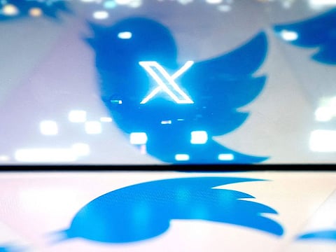 The new X Twitter logo reflected in the bird Twitter logo.