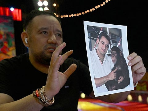 Mexican circus owner Raul Gasca, ex-owner of Pancho, one of the chimpanzees killed after escaping from the Ukumari Park in the city of Pereira, shows a picture in which he is holding the ape, at the Gasca Brothers Circus in Cali, Valle del Cauca Department, Colombia, on July 24, 2023. 