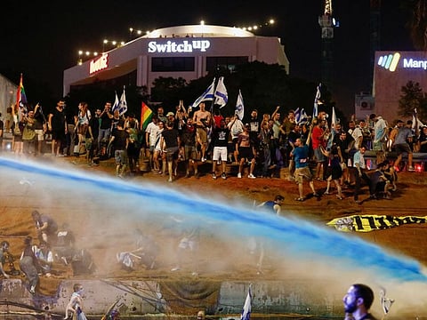 Police use water cannon as protesters block Ayalon Highway during a demonstration following a parliament vote on a contested bill that limits Supreme Court powers to void some government decisions, in Tel Aviv, Israel July 24, 2023.  