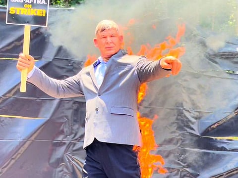 Mike Massa, who has been a stunt coordinator for more than 30 years, performs a fire stunt Monday at a SAG-AFTRA strike in Georgia. 