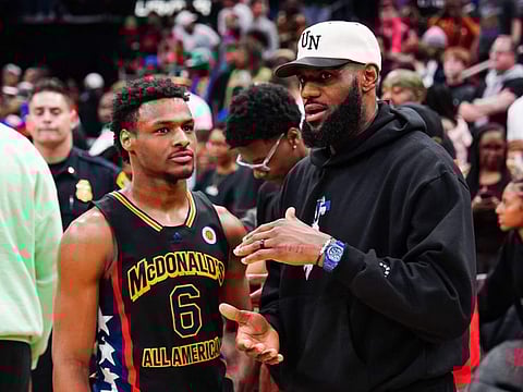 Bronny James chats with Lebron James after the 2023 McDonald's High School Boys All-American Game at Toyota Center in Houston in March.