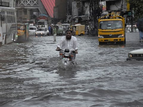 A man cries outside the mortuary after he lost his son by monsoon rains on the outskirts of Islamabad, on July 19, 2023. 