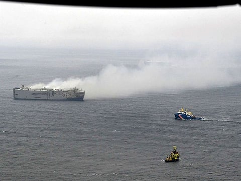 Smoke is seen from a freight ship in the North Sea, about 27 kilometers (17 miles) north of the Dutch island of Ameland, Thursday, July 27, 2023. A cargo ship packed with nearly 3,000 cars was still ablaze Thursday close to a world-renowned bird habitat off the Dutch coast as firefighters and salvage crews waited for the flames to subside before attempting to board the vessel. 