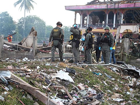 Thai Explosive Ordnance Disposal (EOD) personnel examine the site of an explosion at a firework warehouse in Narathiwat province southern Thailand, Saturday, July 29, 2023. 