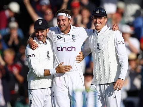 England's Stuart Broad celebrates with James Anderson and Zak Crawley after taking the wicket of Australia's Alex Carey on Monday.