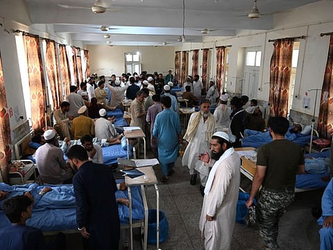 Relatives gather inside a ward of bomb blast victims at a hospital in Bajaur district of Khyber-Pakhtunkhwa province on July 31, 2023.  