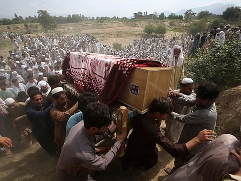 Relatives and mourners carry the casket of a victim, who was killed in Sunday's suicide bomber attack in the Bajur district of Khyber Pakhtunkhwa, on  July 31, 2023.  