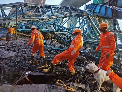 India's National Disaster Response Force members inspecting the site of an under construction Samruddhi Expressway where a crane collapsed on slab of the bridge in Thane district of India's Maharashtra state.  