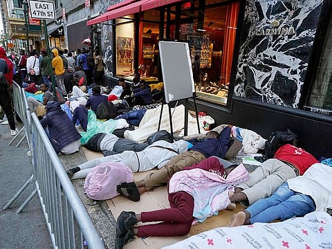 Hundreds of migrants sleep in line early on August 1, 2023, for placement at the Roosevelt Hotel intake center in New York.  