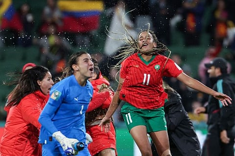 Morocco's goalkeeper Khadija Er-Rmichi (left) and forward Fatima Tagnaout celebrate their team's victory and qualification to the knockout stage in the Women's World Cup at Perth Rectangular Stadium in Perth on Thursday.