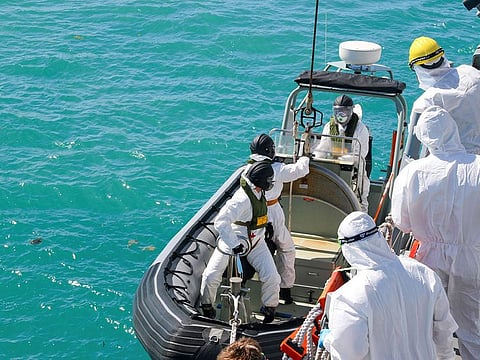 Sailors from HMAS Brisbane prepare to board a rigid-Hulled inflatable boat to conduct search and rescue operations in the vicinity of Lindeman Island, Australia, as part of a multi-national and multi-agency search and rescue effort following an Australian Army MRH-90 Taipan helicopter ditching in waters near the island. 