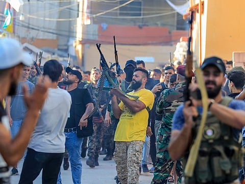 Members of the Palestinian Fatah Movement fire in the air during the funeral procession of Abu Ashraf Al Armoushi, the Palestinian National Security Commander in the Saida region, at Rashidiyeh Palestinian refugee camp, southern Lebanon, Monday, July 31, 2023.  