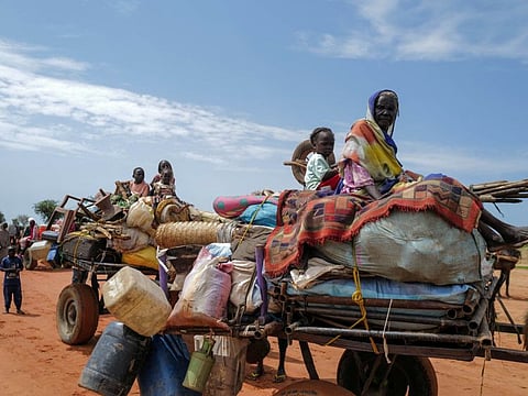 Sudanese people, who fled the conflict in Murnei in Sudan's Darfur region, ride carts upon crossing the border between Sudan and Chad in Adre, Chad August 2, 2023.  
