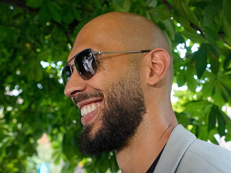 Andrew Tate smiles as he leaves the Court of Appeal in Bucharest, Romania, on Aug. 1, 2023.