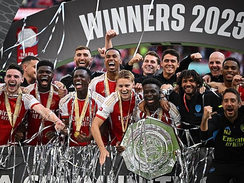 Arsenal's Bukayo Saka, Martin Odegaard and teammates celebrate with the Community Shield trophy at Wembley Stadium on Sunday