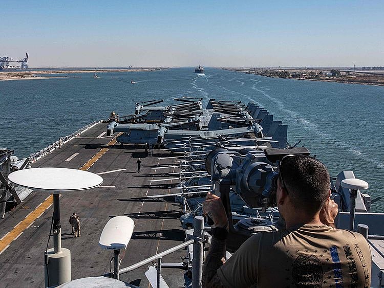 This handout photo released on August 6, 2023 by the US Defence Visual Information Distribution Service (DVIDS) shows A US Navy sailor from USS Bataan (LHD 5) monitoring as the amphibious assault ship transits the Suez Canal with the 26th Marine Expeditionary Unit (MEU). 