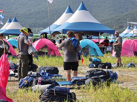 US scout members prepare to leave the World Scout Jamboree campsite in Buan, South Korea, Sunday, Aug. 6, 2023.  