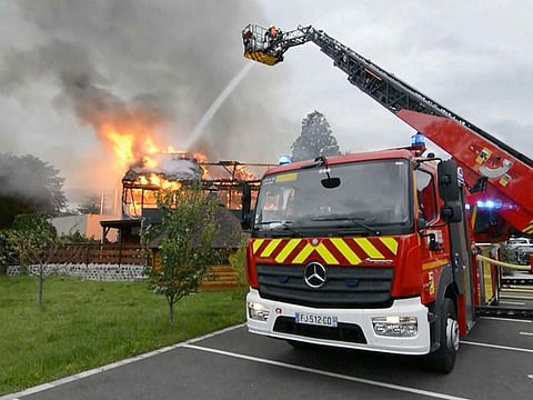 Firefighters try to contain the blaze at a vacation home in the town of Wintzenheim, north-eastern France, Wednesday Aug. 9, 2023. 