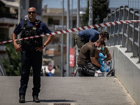  Greek police experts search for evidence outside AEK Athens' OPAP Arena on August 8, 2023 after a Greek football fan was stabbed to death on the outskirts of Athens during a brawl between rival club supporters, with 96 people arrested in violent clashes. 