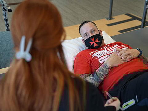 Patient Mike Camilleri works with physical therapist Beth Hughes.