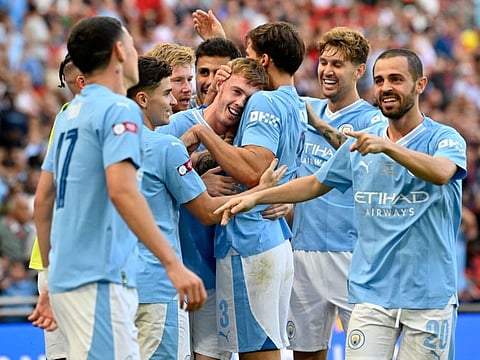 Manchester City's players celebrate during the FA Community Shield football match against Arsenal at Wembley Stadium, in London on August 6.