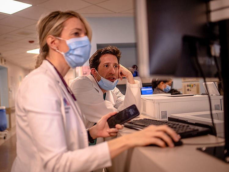 Doctors Milekic and Matthew Levin look at patients who the AI program has predicted are the most at risk. 