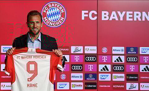 Bayern Munich's English forward Harry Kane poses with his jersey during a press conference on his presentation after signing a four-year deal with Bayern Munich, in Munich, southern Germany on Sunday.