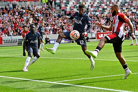 Tottenham Hotspur's defender Emerson Royal (centre) attempts to block a cross from Brentford's striker Bryan Mbeumo during a Premier League match at Gtech Community Stadium in London on Sunday.