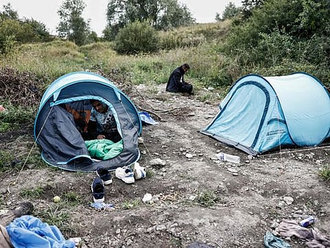 This photograph taken on August 12, 2023, shows tents of migrants installed at a makeshift camp in Loon-Plage, northern France. Six people have been killed as a boat carrying migrants heading to Britain sank in the Channel. Five French ships and a helicopter, as well as two British vessels, were involved in a rescue operation while some passengers were still missing, and about 50 migrants were rescued, some of them by the British vessels, the authorities said.  