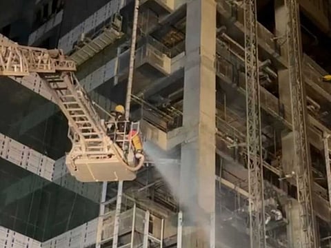 Firefighters extinguish the fire at a building under construction in Riyadh on Thursday, August 17, 2023. 