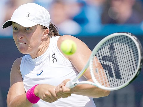 Iga Swiatek of Poland returns a shot to Marketa Vondrousova of the Czech Republic during their quarterfinal match in Cincinnati at the Western & Southern Open, in Mason, Ohio.   