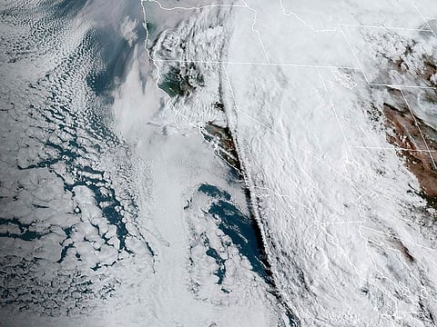 EDT satellite image provided by the National Oceanic and Atmospheric Administration shows Tropical Storm Hilary, right, off Mexico’s Pacific coast.
