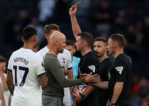 Manchester United's manager Erik ten Hag is shown a yellow card by referee Michael Oliver at the end of the Premier League match against Tottenham Hotspur in London on Saturday.