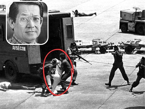 The body of former Philippine Senator Benigno "Ninoy" Aquino Jr (in white), being carried by members of the Aviation Security Command after he was felled by a bullet to the head on August 21, 1983. Inset, a photo of Ninoy Aquino Jr. The Manila airport where he was assassinated now bears his name.