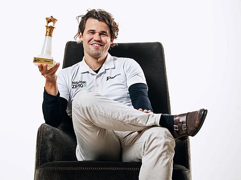 Norwegian world champion Magnus Carlsen poses for a picture with the trophy after clinching the title of the International Chess Federation World Cup 2023 in Baku, on Thursday.