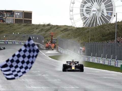 Red Bull's Max Verstappen passes the chequered flag to win the Dutch Grand Prix yesterday.