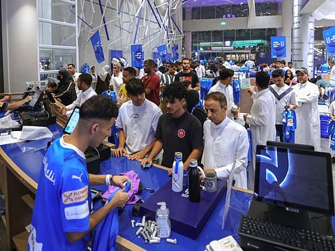 Fans of Saudi football club Al Hilal line up to buy T-shirts bearing the name and number of Brazilian forward Neymar Jr. at the club's official store in Riyadh on August 15.