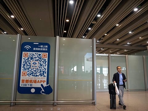 A traveler walks through the international flight arrivals area at Beijing Capital International Airport in Beijing.