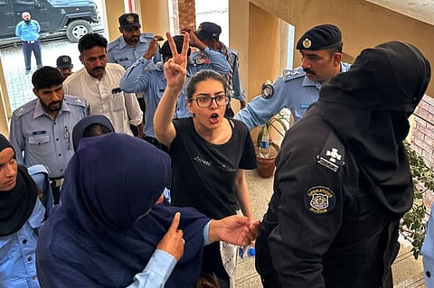 Police officials present arrested lawyer and human rights activist Imaan Mazari-Hazir (centre) before a court in Islamabad on August 20, 2023.  