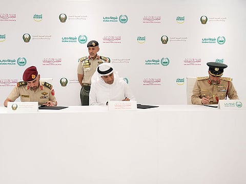 (From L-R) Lieutenant General Abdullah Khalifa Al Marri, Abdulla Mohammed Al Basti and Major General Staff Mohammed Khalfan Al Mehairi during the MoU signing ceremony to extend benefits of Esaad cards to larger section of communities.