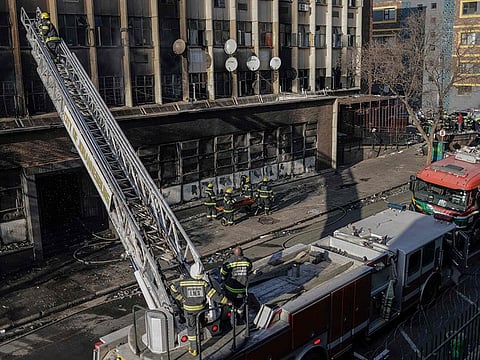 Firefighters work at the scene of a fire in Johannesburg.