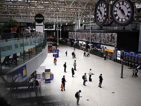 Commuters look at the departures board at the Waterloo train station in London on September 1, 2023 as train drivers strike over pay. 