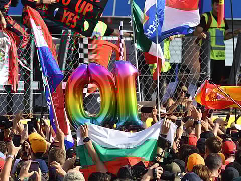Fans holding No 10 balloons in support of the ten victories of the season for Red Bull's Max Verstappen at Italian Grand Prix on Sunday.