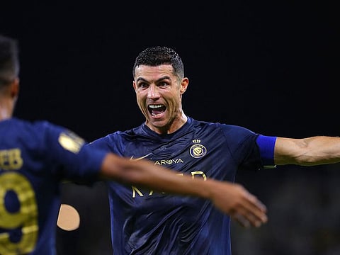 Nassr's Portuguese forward #07 Cristiano Ronaldo (R) celebrates with Nassr's Saudi midfielder #29 Abdulrahman Ghareeb after scoring a goal during the Saudi Pro League football match between Al-Nassr and Al-Hazem at the King Abdullah Sports City in Buraidah, on September 2, 2023.