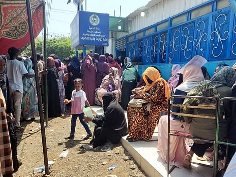 Sudanese queue outside a passport office in Gedaref on September 3, 2023, following an announcement by the authorities of the resumption of issuing passports in war-torn Sudan.  