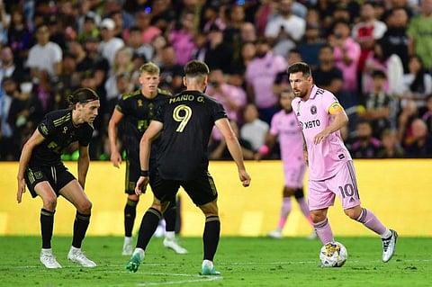 Inter Miami forward Lionel Messi moves the ball against Los Angeles forward Mario Gonzalez during the first half at BMO Stadium.