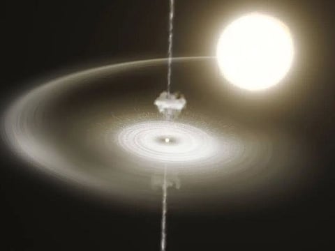 A rendering of the pulsar star (centre) emitting beams from its poles and pulling matter off its companion star (top right)