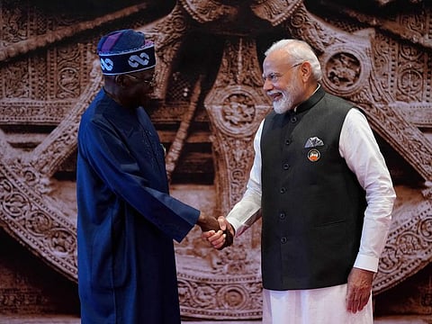 India's Prime Minister Narendra Modi (R) shakes hand with President of Nigeria Bola Ahmed Tinubu.