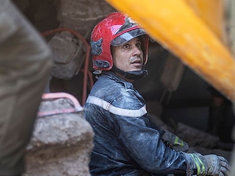 A worker takes part in a rescue operation after the earthquake in Moulay Ibrahim village, near Marrakech, Morocco.
