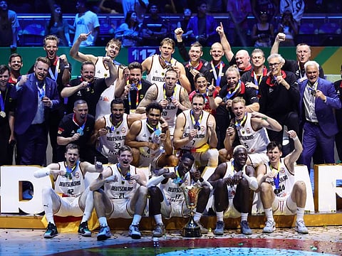 Germany players pose for a picture with the trophy after winning the Fiba World Cup final at the Mall of Asia Arena, Manila, Philippines on Sunday.